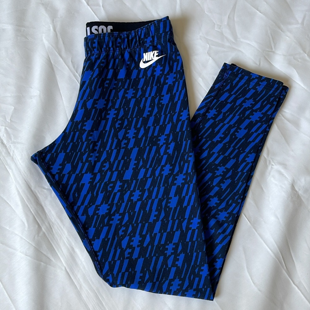 1440- Women’s blue and black leggings with the NIKE lettering hroughout- medium